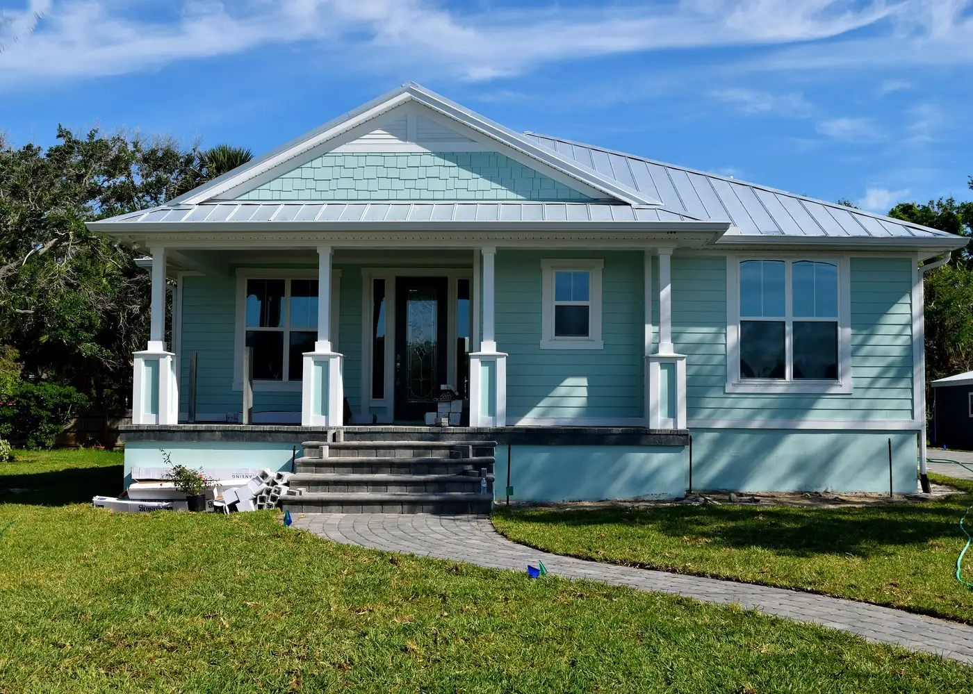 Freshly painted blue cottage with white trim