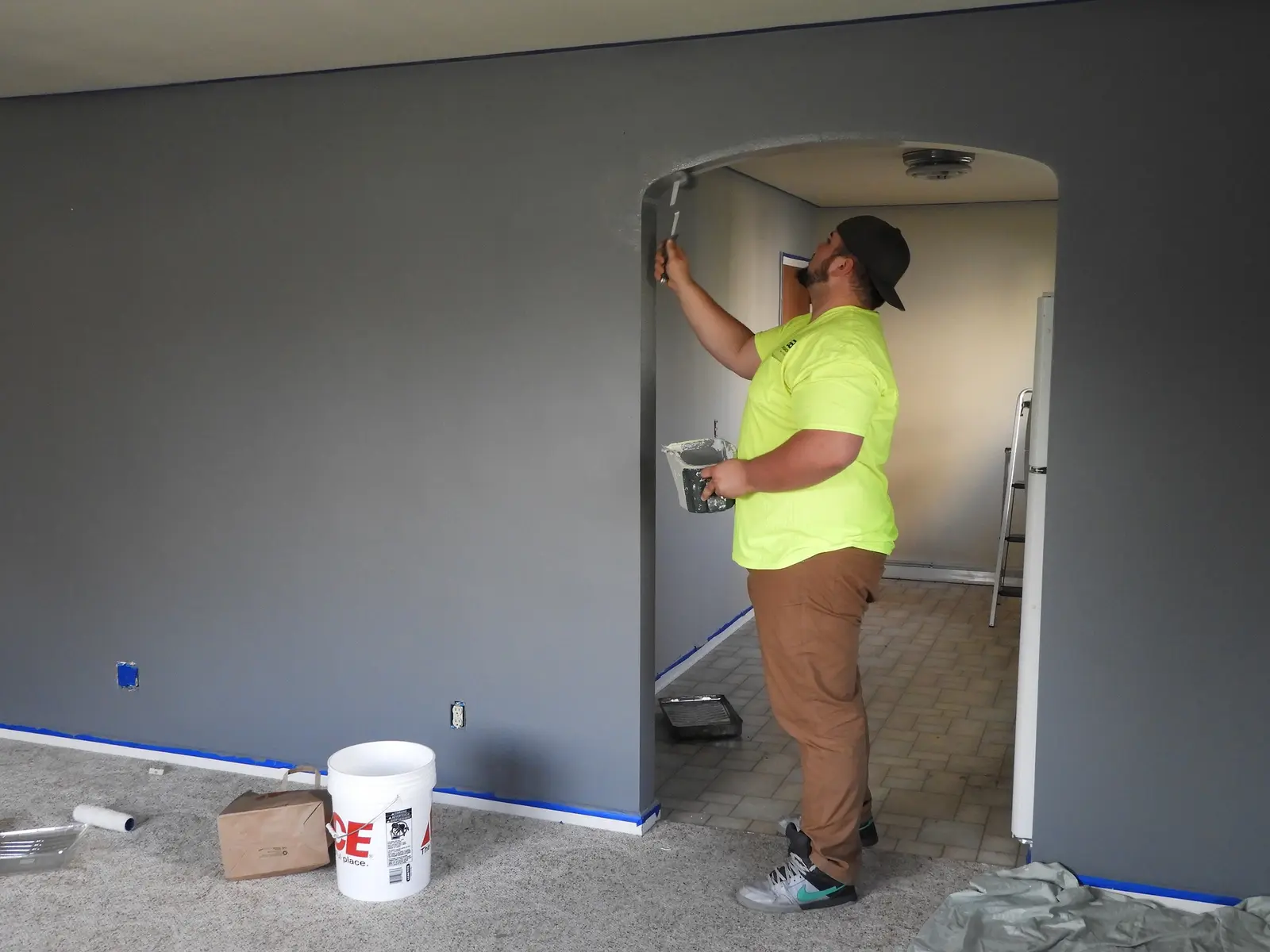 Painter cutting in around an archway